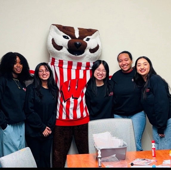 College students standing with University of Wisconsin mascot Bucky Badger