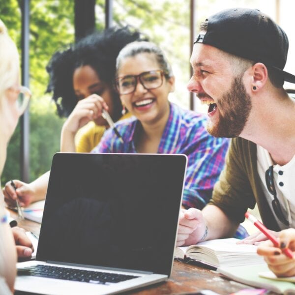 Group of college students studying together and laughing