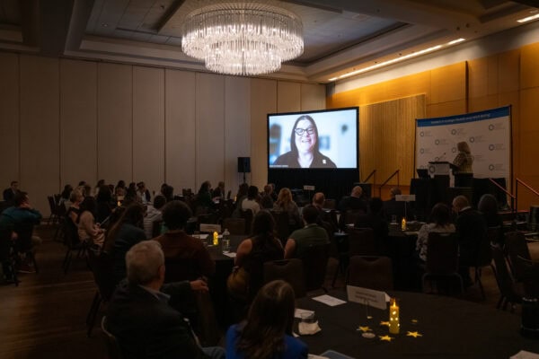 A professional person giving a video address at an awards ceremony