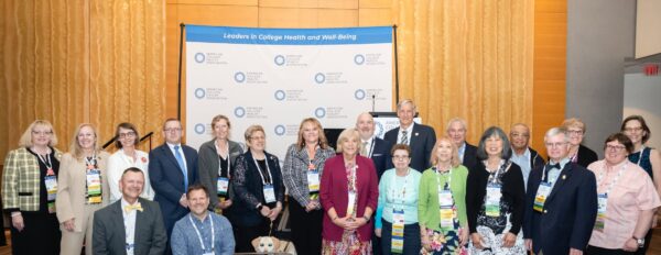 A large group of professional people posing at an awards ceremony