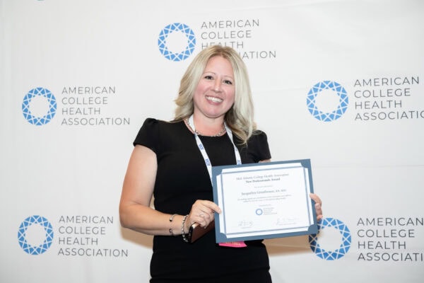 Professional person holding an award certificate