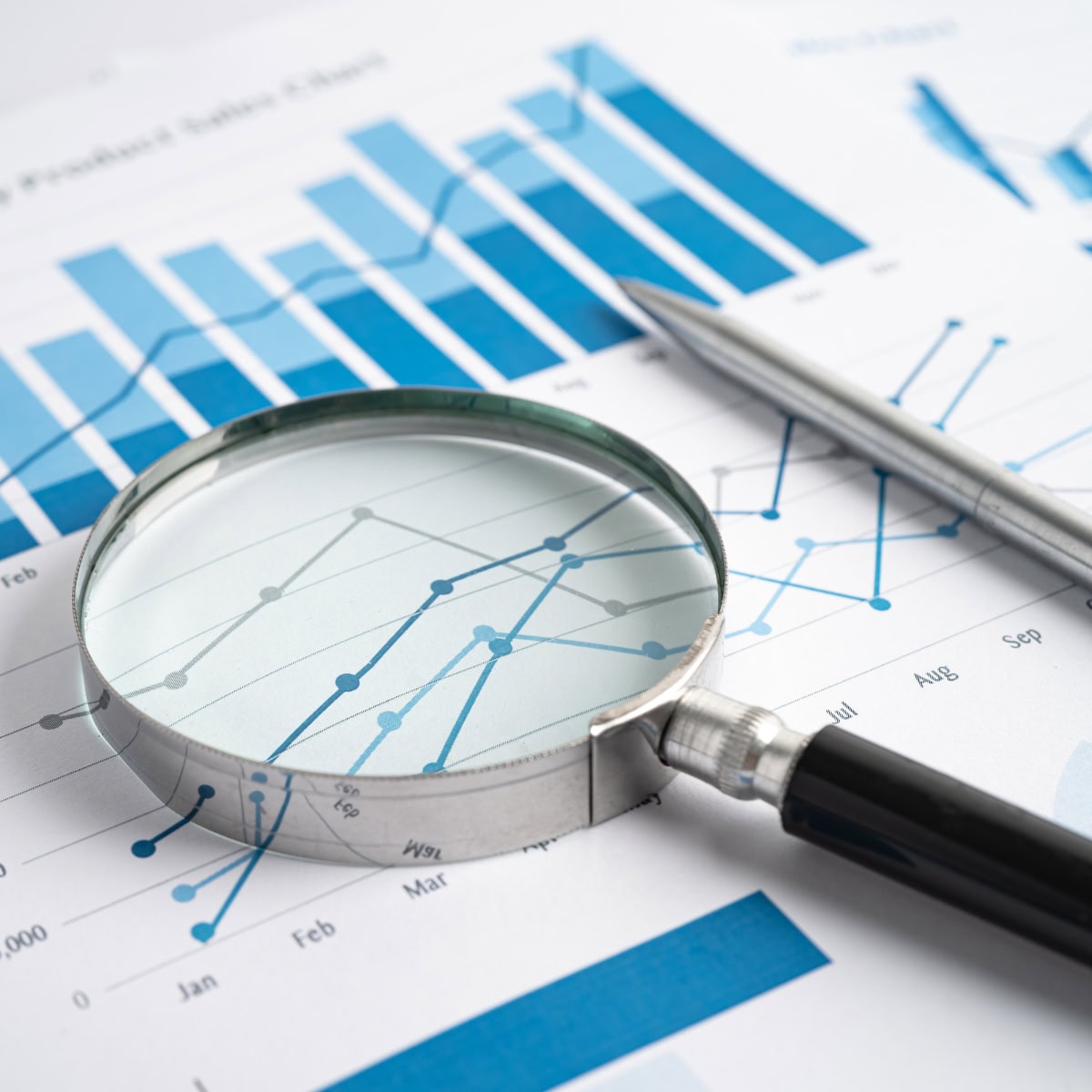 A magnifying glass hovering over a data report