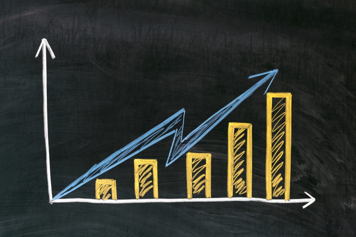 A bar graph depicting an increasing trend written in yellow chalk on a chalkboard