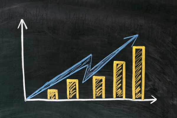 A bar graph depicting an increasing trend written in yellow chalk on a chalkboard