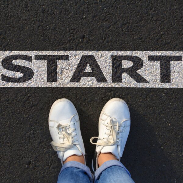 A zoomed in shot of a person standing at the start line on a street