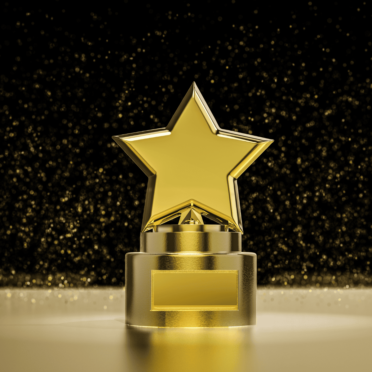 A gold, star-shaped trophy on a table with a black and gold background
