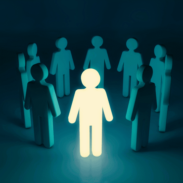 A circle of people made of of blocks, with the front-center person glowing to stand out and indicate leadership