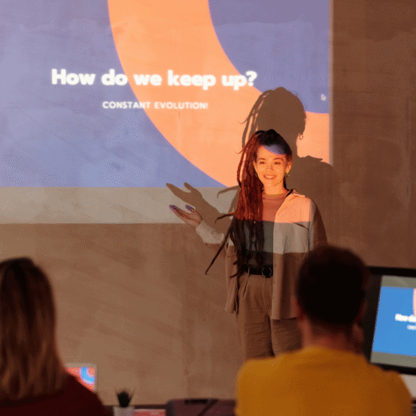 A person giving a presentation in front of a screen