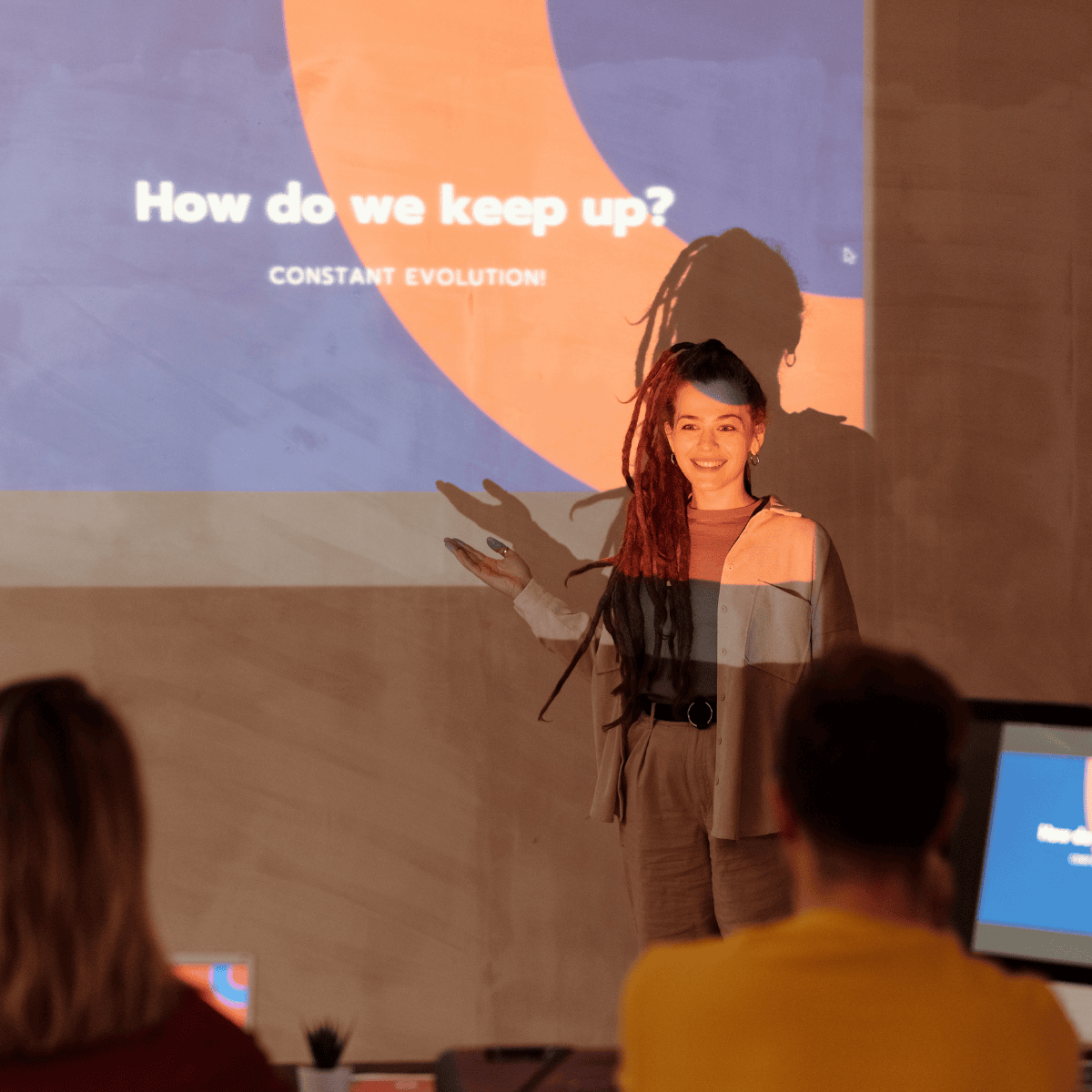 A person giving a presentation in front of a screen