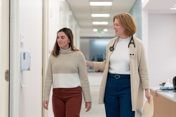 Dr. Hayden walking through the student health center with a patient
