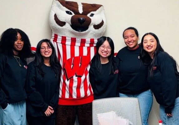 College students standing with University of Wisconsin mascot Bucky Badger