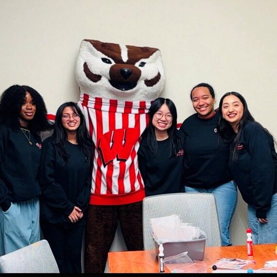 College students standing with University of Wisconsin mascot Bucky Badger