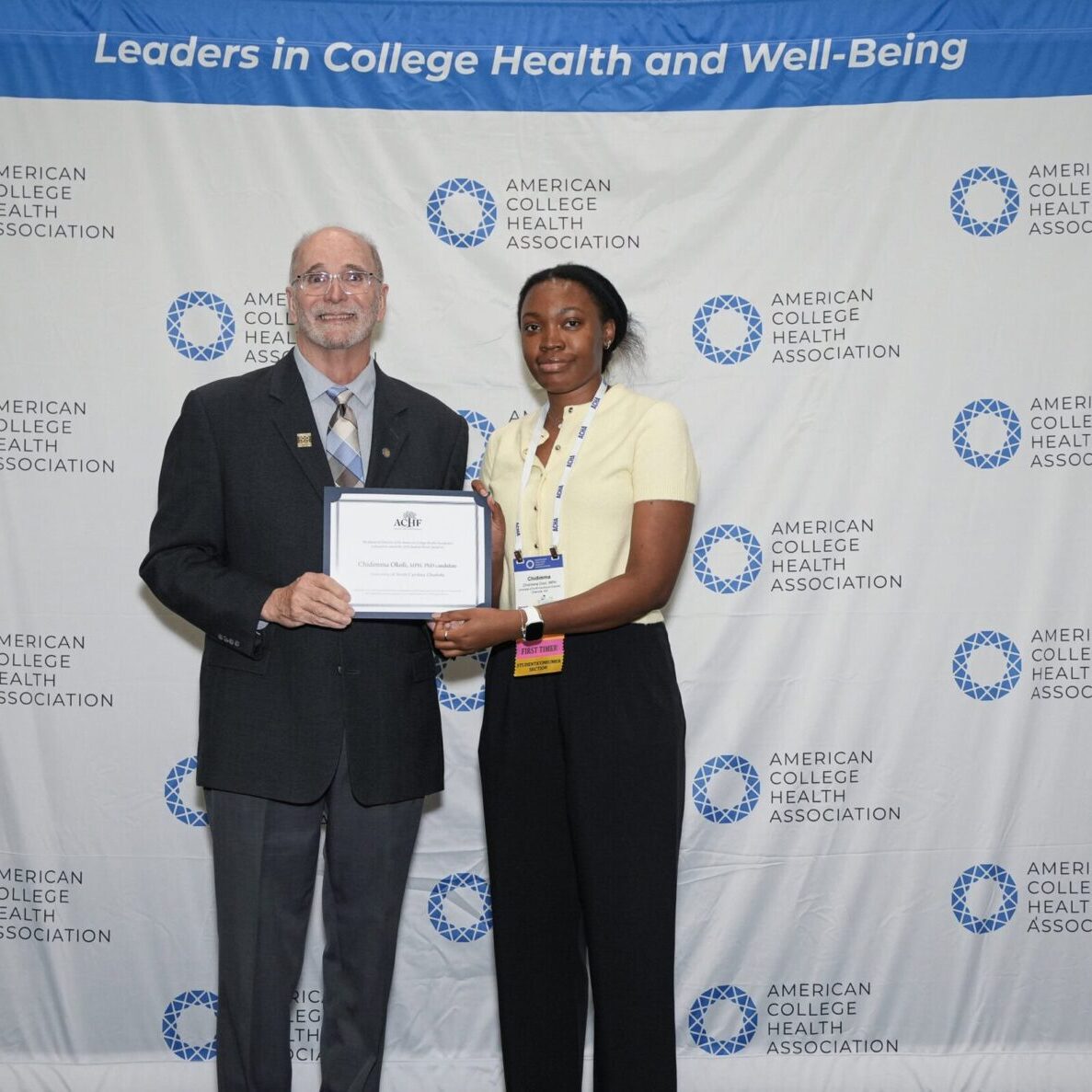 ACHF Chair Michael Huey presenting a certificate to ACHF Award Recipient Chidimma Okoli