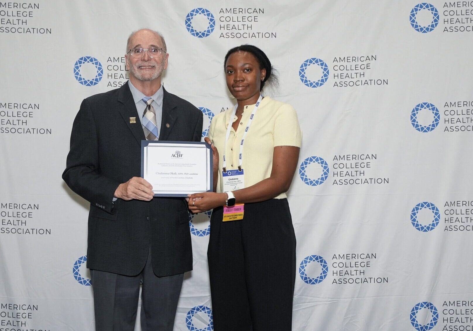 ACHF Chair Michael Huey presenting a certificate to ACHF Award Recipient Chidimma Okoli