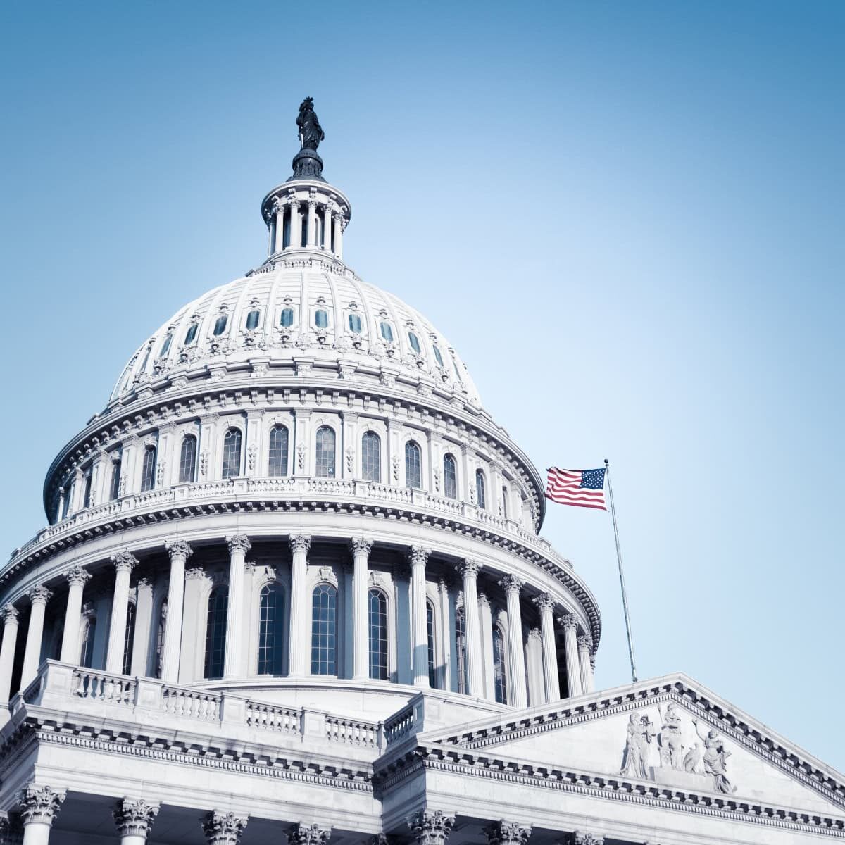 United States Capitol building with a blue sky in the background
