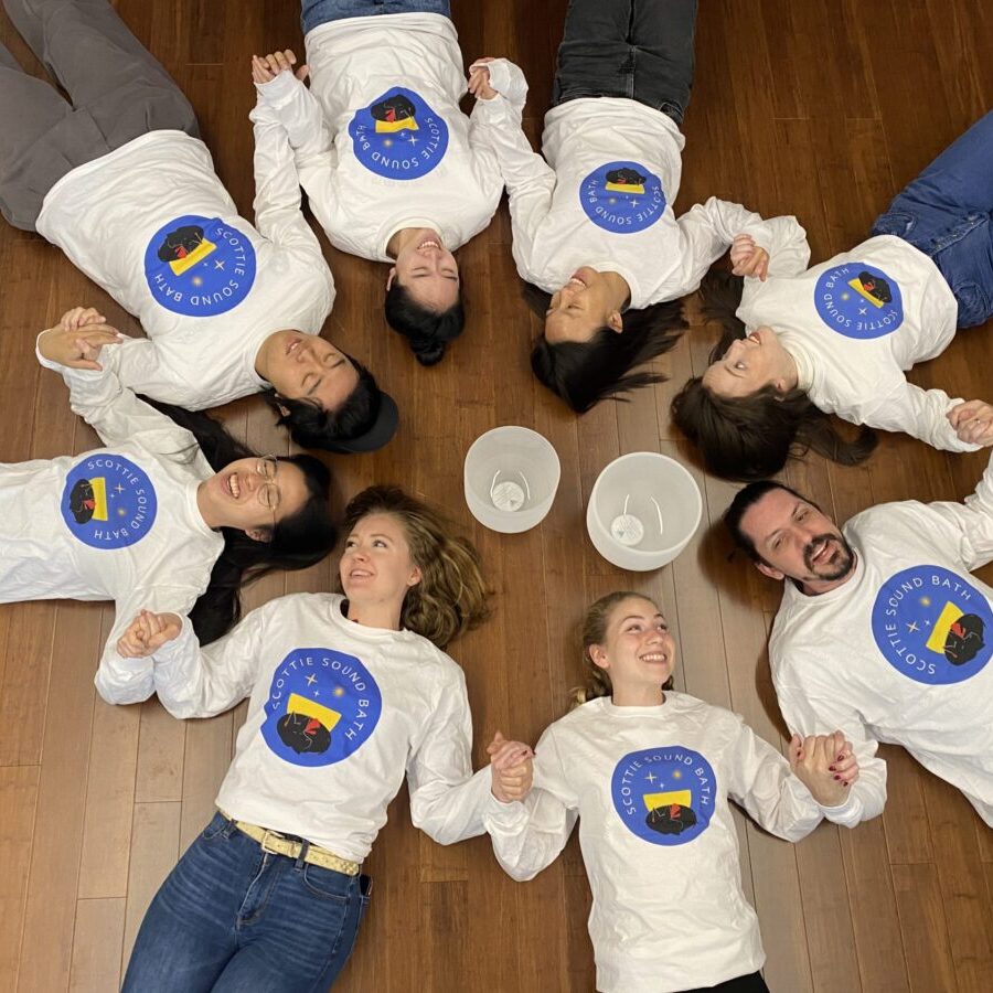 Happy students laying in circle taking part in vibroacoustic therapy, or sound baths