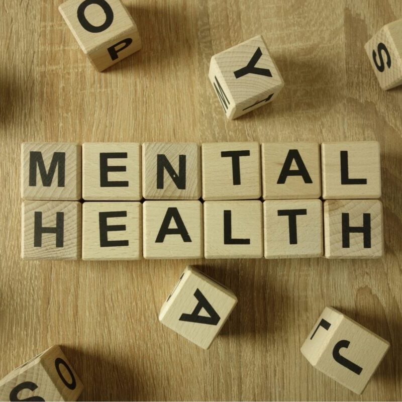 Letter blocks on a table spelling out Mental Health