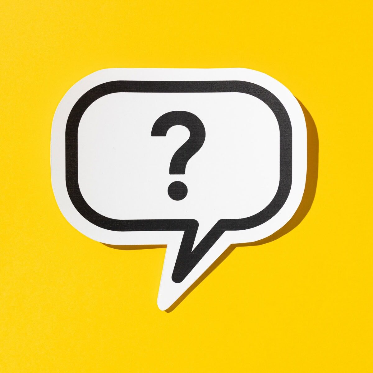 A question mark in a white speech bubble on a yellow background
