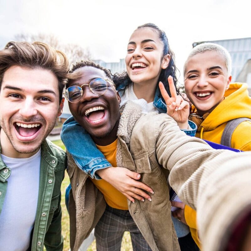 Happy group of friends having fun together outside school