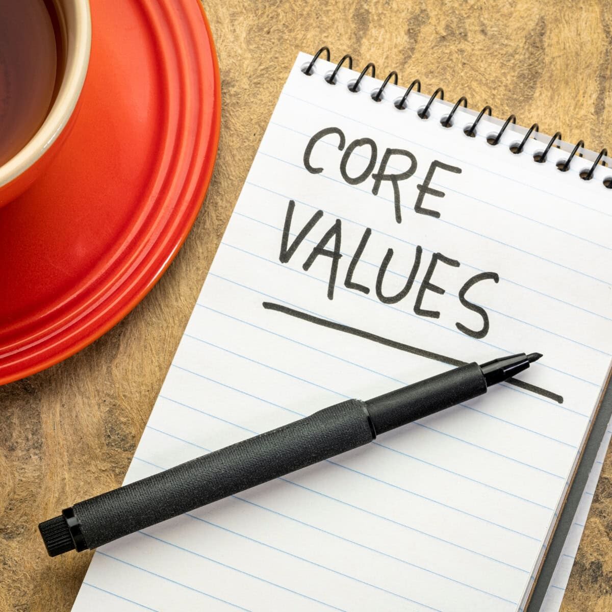 A notebook with Core Values written on it in black ink