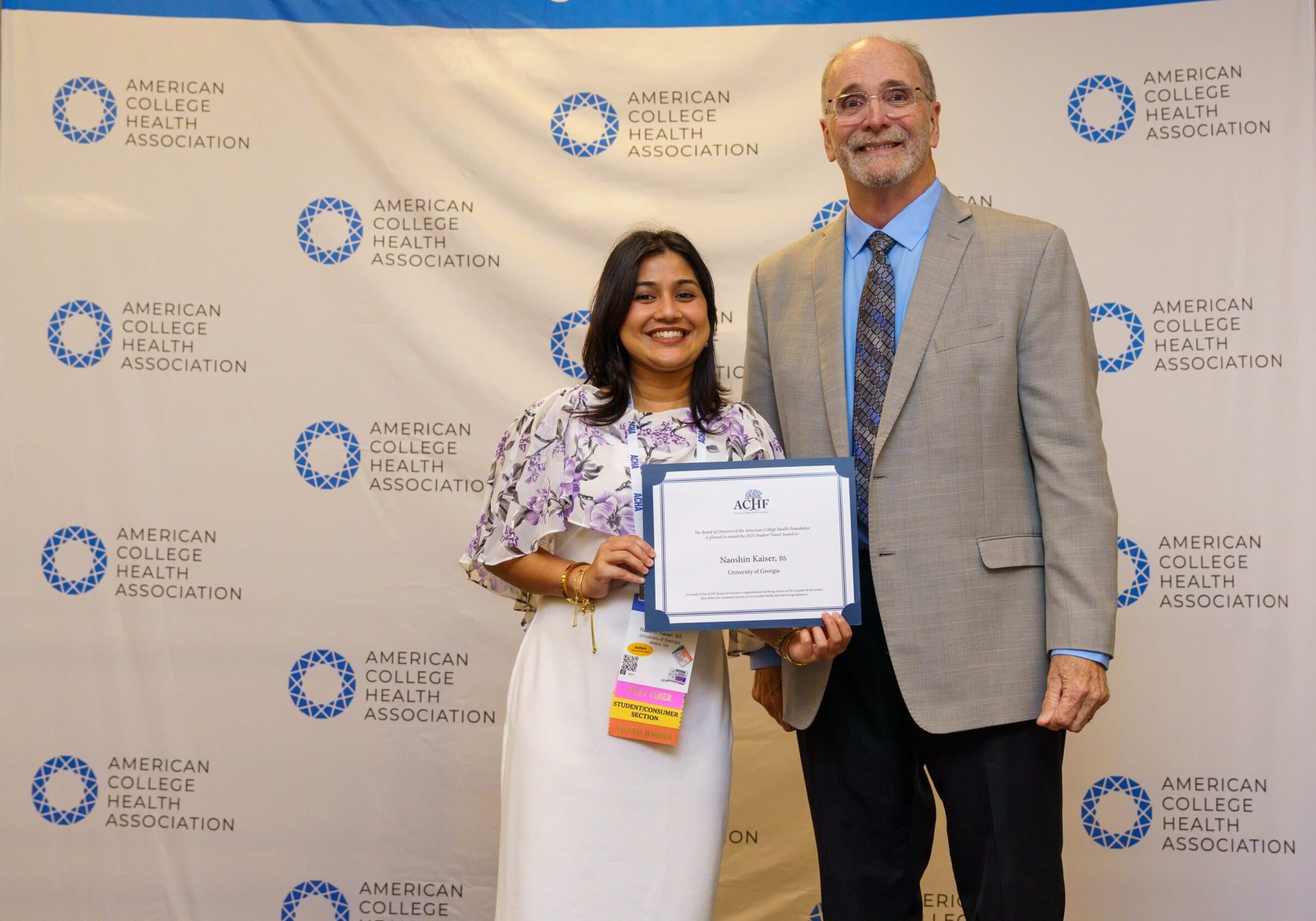 Award recipient Naoshin Kaiser being presented with a certificate by ACHF chair Mike Huey