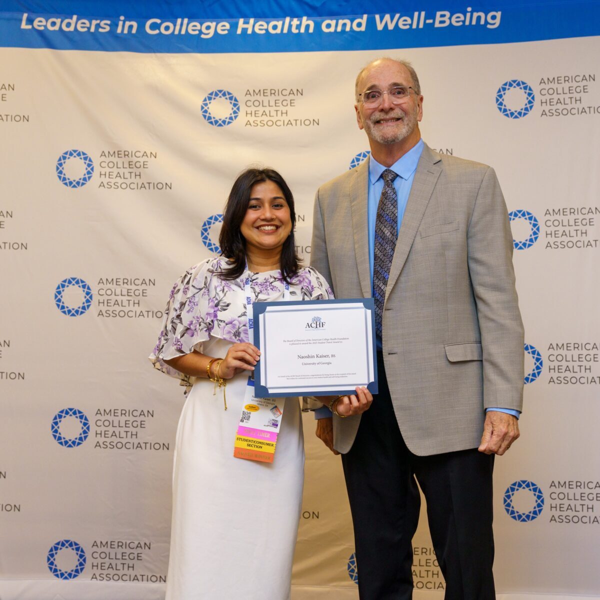 Award recipient Naoshin Kaiser being presented with a certificate by ACHF chair Mike Huey